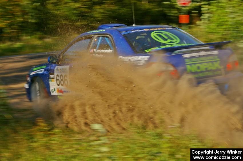 Heath Nunnemacher / Kim DeMotte sling gravel at a right-hander on SS3 in their Subaru WRX.