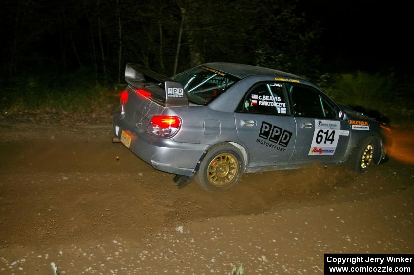 Piotr Wiktorczyk / Chrissie Beavis fly through a fast left-hander on SS5 in their Subaru WRX STi.