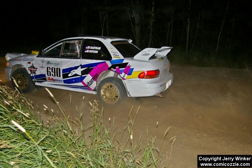 Kenny Bartram / Dennis Hotson blast away from a fast 90-left on SS6 in their Subaru Impreza.