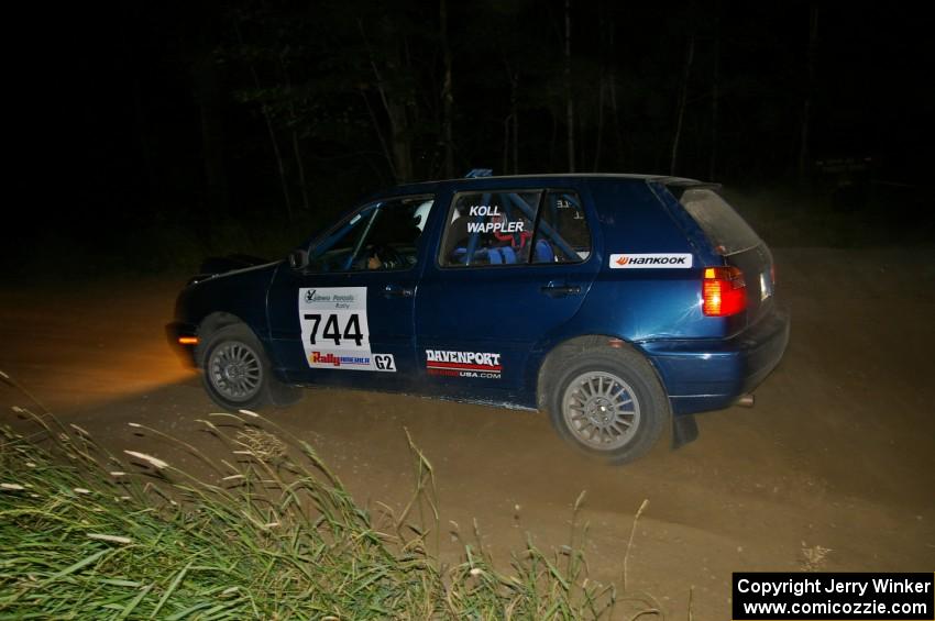 Paul Koll / Matt Wappler accelerate out of a left-hander in their VW Golf.