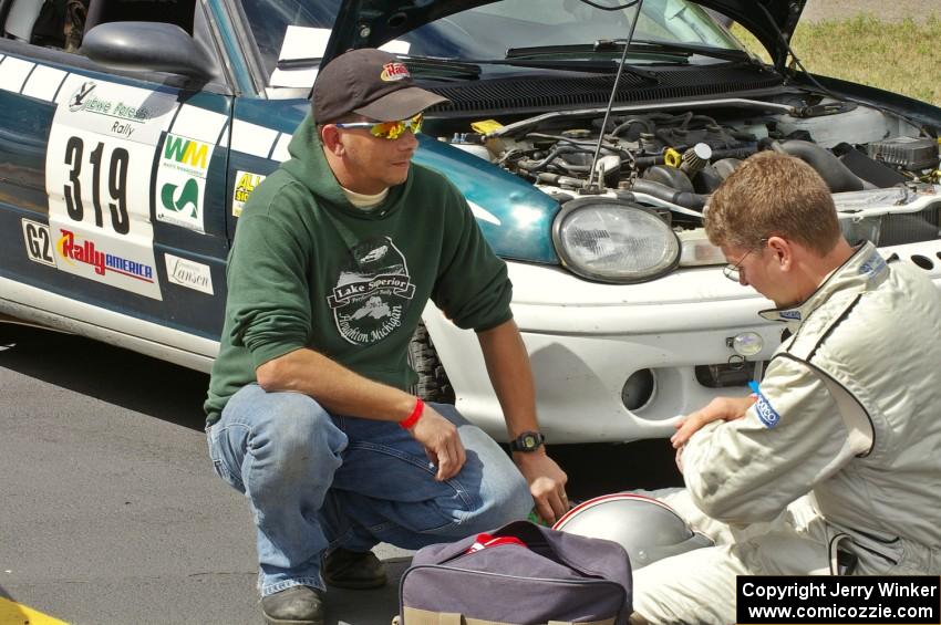 Chris Greenhouse (on the right) confers with a crew member for his Plymouth Neon. Don DeRose was his co-driver for the event.