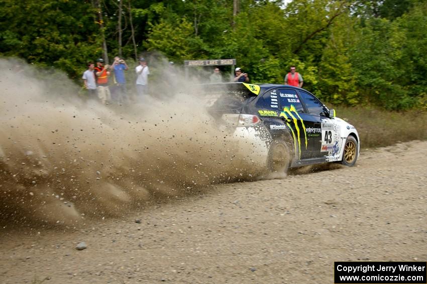 Ken Block / Alex Gelsomino sling gravel through a fast corner on SS10 in their Subaru WRX STi.