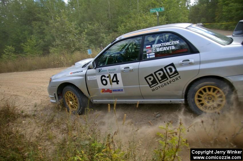 Piotr Wiktorczyk / Chrissie Beavis hug close to the apex of a fast left-hander on SS10 in their Subaru WRX STi.