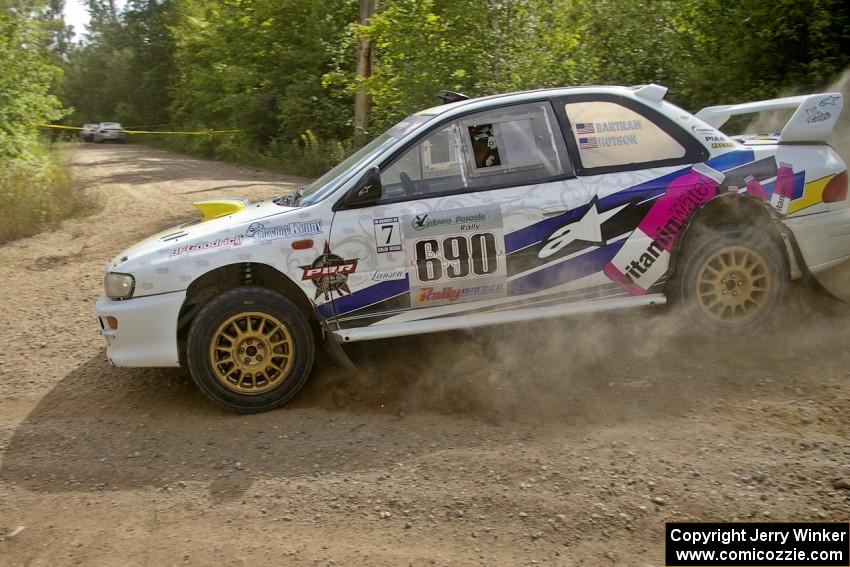 The Subaru Impreza of Kenny Bartram / Dennis Hotson drifts wide at a fast left-hander on SS10.