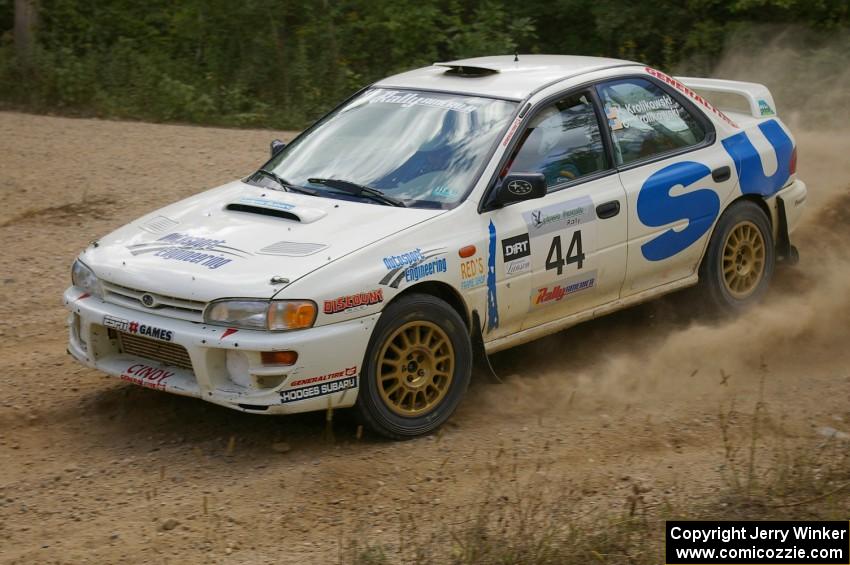 Henry Krolikowski / Cindy Krolikowski drift through a fast sweeper on SS10 in their Subaru Impreza.