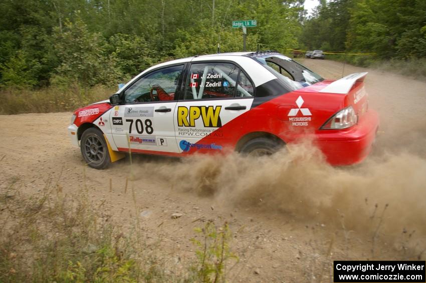 Jan Zedril / Jody Zedril kick up plumes of silt at a left-hander on SS12 in their Mitsubishi Lancer ES.