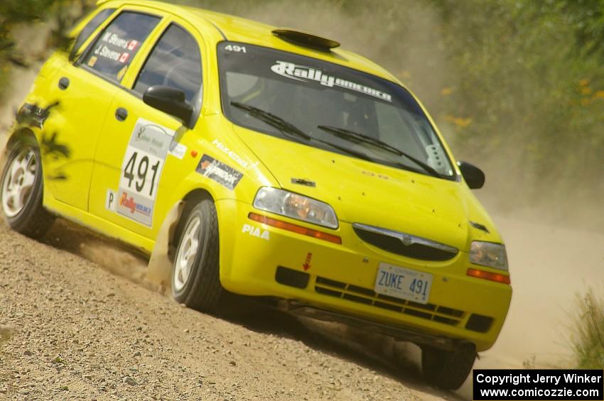 The Jim Stevens / Marianne Stevens Suzuki Swift drifts through a sweeper on SS10.