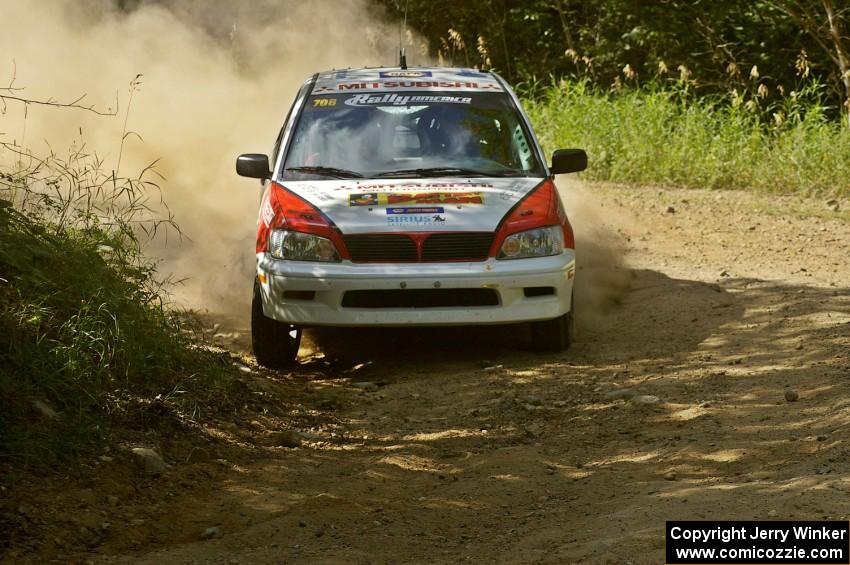 Jan Zedril / Jody Zedril apex a right-hander on SS12 in their Mitsubishi Lancer ES.