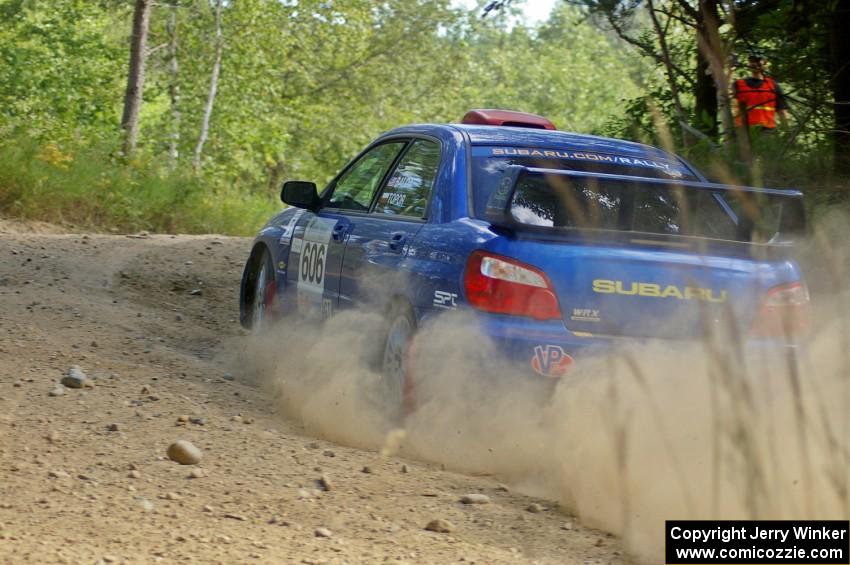 Slawomir Balda / Janusz Topor sling gravel through an uphill right-hander on SS12 in their Subaru WRX STi.