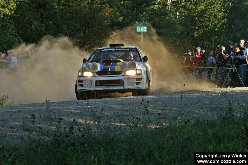 The Kenny Bartram / Dennis Hotson Subaru Impreza slings gravel at the spectator location on SS13.