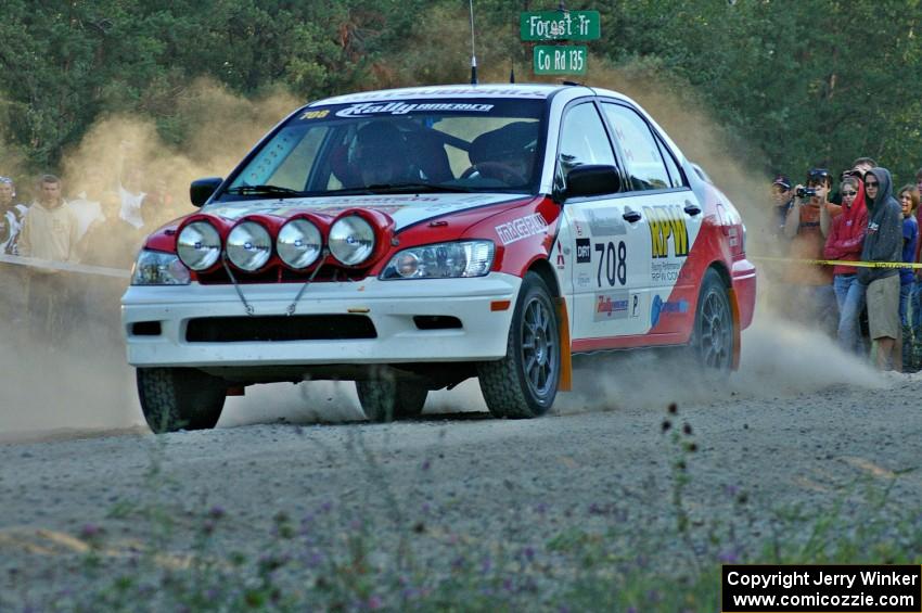 Jan Zedril / Jody Zedril accelerate from the spectator location on SS13 in their Mitsubishi Lancer ES.