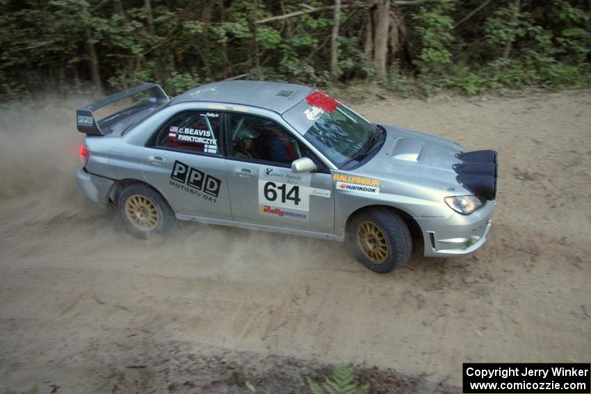 Piotr Wiktorczyk / Chrissie Beavis drift wide through a corner on SS15 in their Subaru WRX STi.