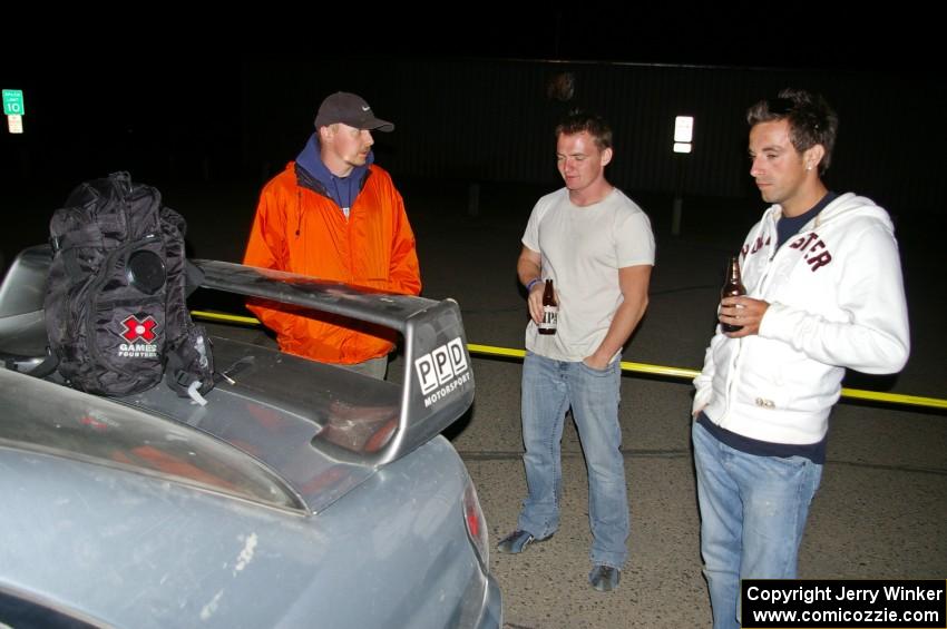 Piotr Wiktorczyk and crew take a breather behind their Subaru WRX STi at the end of the event.