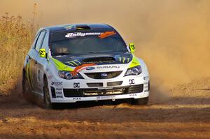 Ken Block / Alex Gelsomino drift through a sweeper on the practice stage in their Subaru WRX STi.