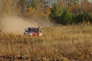 Dustin Kasten / Dave Parps at speed in their Subaru Impreza through a fast section of the practice stage.