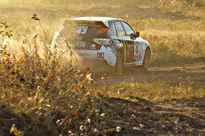 Ken Block / Alex Gelsomino power out of a corner on the practice stage in their Subaru WRX STi.