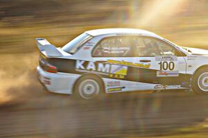 The Andi Mancin / Maciej Wislawski Mitsubishi Evo 9 at speed on the practice stage.