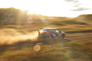 The Andrew Comrie-Picard / Marc Goldfarb Mitsubishi Lancer Evo 9 RS at speed down a straight on the practice stage.