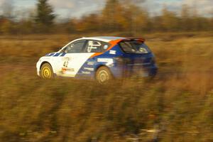Eric Burmeister / Dave Shindle at speed down a straight on the practice stage in their Mazda Speed 3.