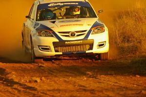 Eric Burmeister / Dave Shindle drift out of a fast sweeper on the practice stage in their Mazda Speed 3.