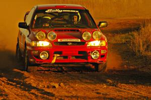 Dustin Kasten / Corina Soto at speed out of a fast sweeper on the practice stage in their Subaru Impreza.