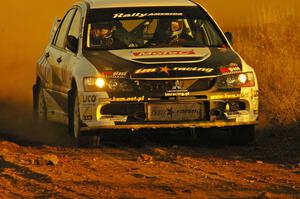 The Andi Mancin / Maciej Wislawski Mitsubishi Evo 9 blasts out of a sweeper on the practice stage.