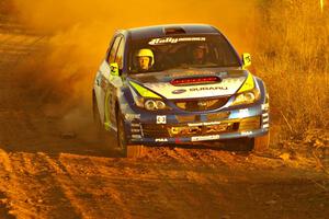 Travis Pastrana gives a female worker a ride in his Subaru WRX STi on the practice stage.