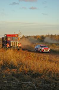 Arkadiusz Gruszka / Michal Chodan blast past a gravel truck stationed on the outside of a sweeper on the practice stage in their