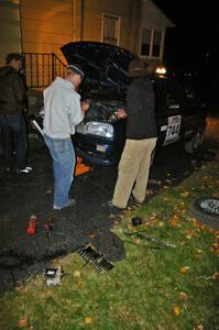 Matt Himes and Paul Koll work on the tranny of Paul's VW Golf in the Seidels driveway.