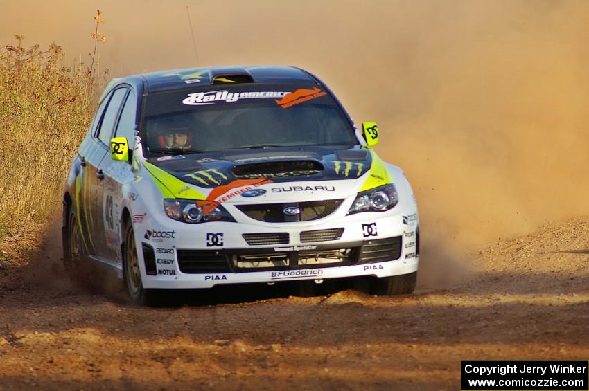 Ken Block / Alex Gelsomino drift through a sweeper on the practice stage in their Subaru WRX STi.