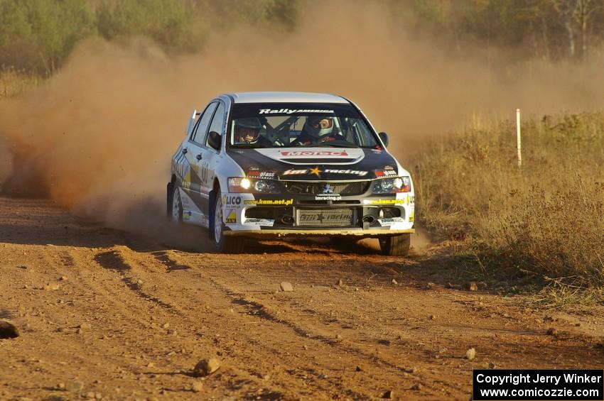 Andi Mancin / Maciej Wislawski drift their Mitsubishi Evo 9 out of a sweeper on the practice stage.