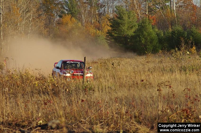 Dustin Kasten / Dave Parps at speed in their Subaru Impreza through a fast section of the practice stage.