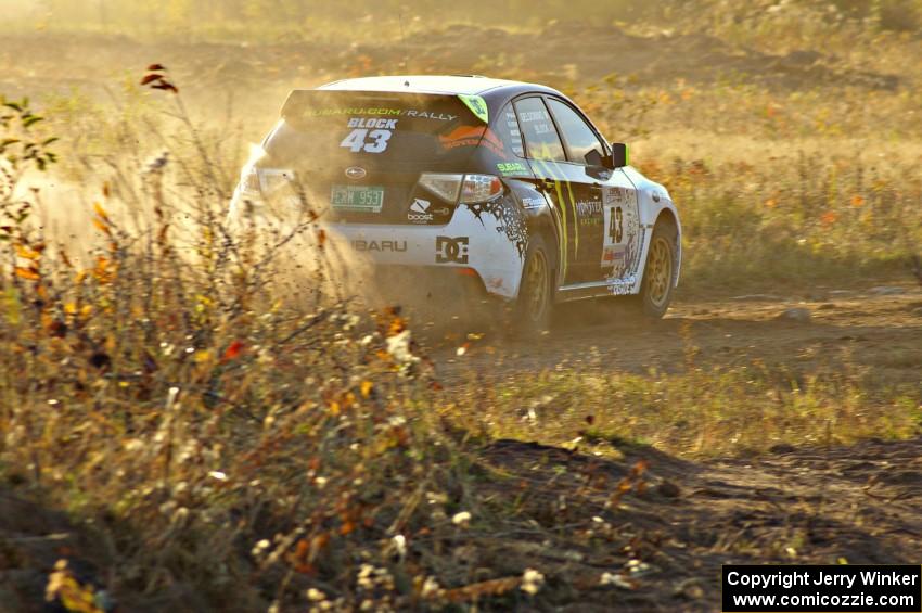 Ken Block / Alex Gelsomino power out of a corner on the practice stage in their Subaru WRX STi.