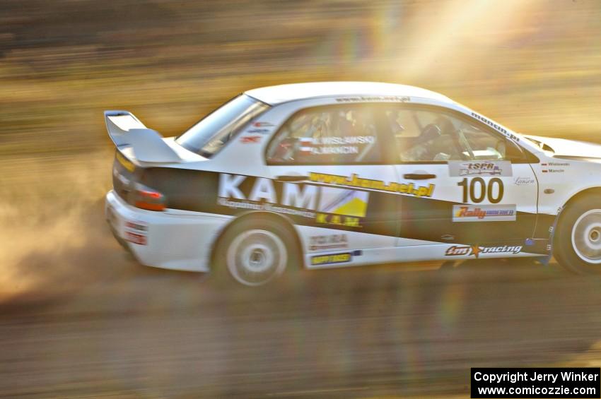 The Andi Mancin / Maciej Wislawski Mitsubishi Evo 9 at speed on the practice stage.