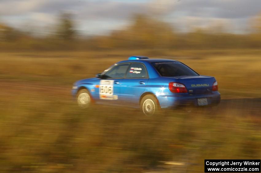 Slawomir Balda / Janusz Topor accelerate on a long straight on the practice stage in their Subaru WRX.