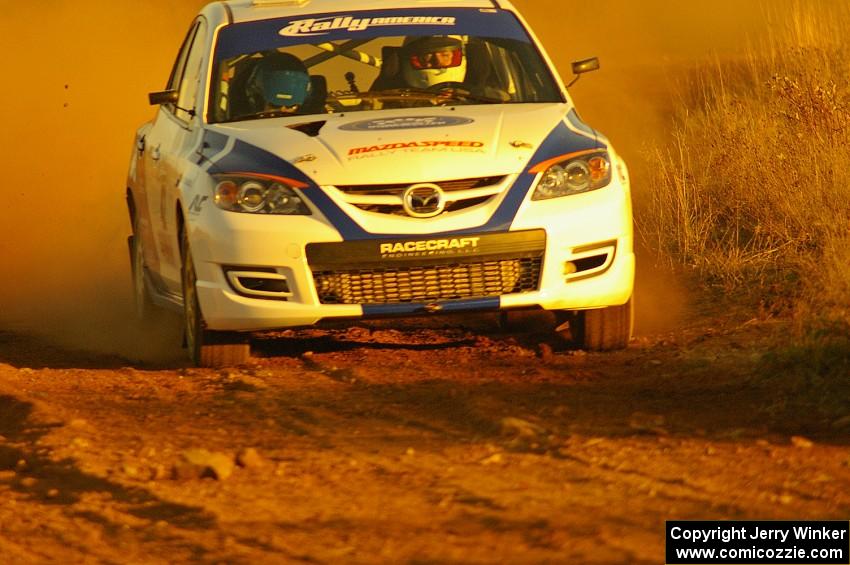 Eric Burmeister / Dave Shindle drift out of a fast sweeper on the practice stage in their Mazda Speed 3.