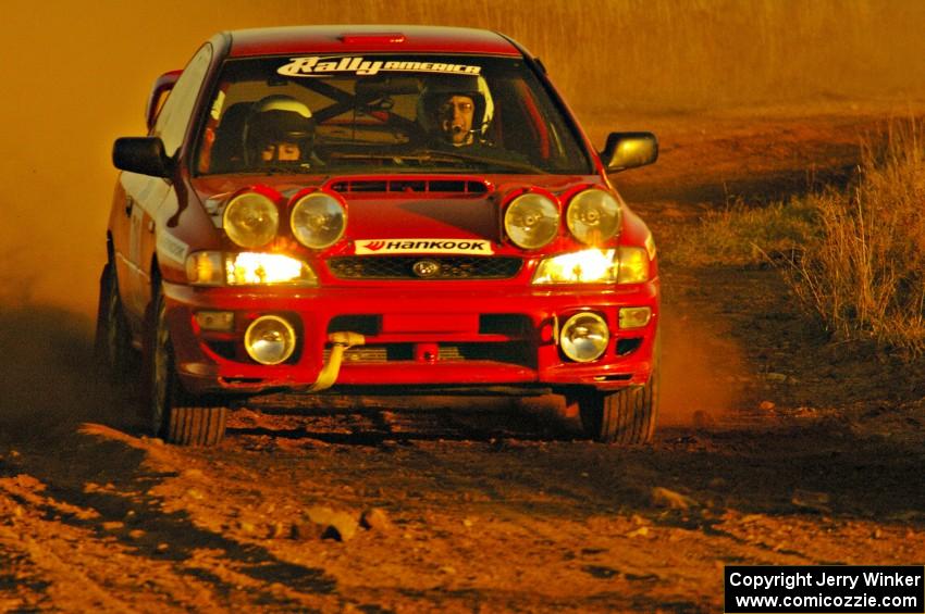 Dustin Kasten / Corina Soto at speed out of a fast sweeper on the practice stage in their Subaru Impreza.
