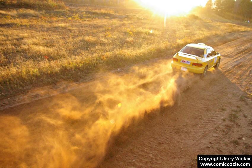Kyle Sarasin / Mikael Johansson at speed down a straight on the practice stage in their Subaru Impreza.