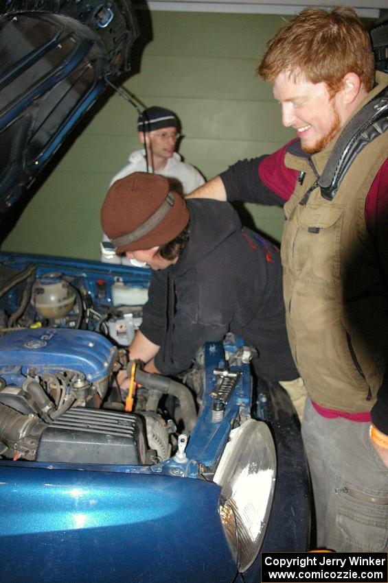 Ben Slocum annoys Paul Koll while he switches out the transmission on his VW Golf. Matt Himes is in the background.(1)