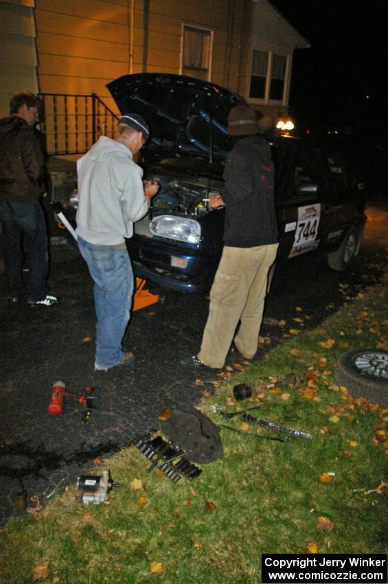 Matt Himes and Paul Koll work on the tranny of Paul's VW Golf in the Seidels driveway.