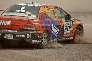 Andrew Comrie-Picard / Marc Goldfarb spin, stall and refire their Mitsubishi Lancer Evo 9 RS at the SS1 spectator point.