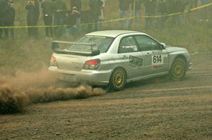 Piotr Wiktorczyk / Alan Dolan powers uphill through the dust on SS1 in their Subaru WRX STi.