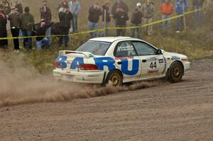 Henry Krolikowski / Cindy Krolikowski power out of a left-hander at the spectator point on SS1 in their Subaru Impreza.