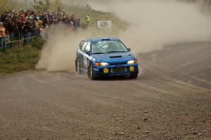 Dmitri Kishkarev / Kim DeMotte come into the spectator point of SS1, Green Acres, in their Mitsubishi Lancer Evo IV.