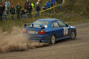 The Dmitri Kishkarev / Kim DeMotte Mitsubishi Lancer Evo IV accelerates hard out of the spectator point of SS1, Green Acres.