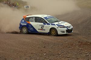 Eric Burmeister / Dave Shindle throw their Mazda Speed 3 hard into the spectator corner on SS1, Green Acres.