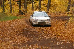 Henry Krolikowski / Cindy Krolikowski drift through a leaf covered corner on SS2, Beacon Hill, in their Subaru Impreza.