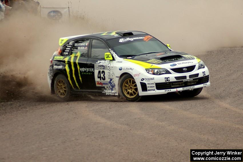 Ken Block / Alex Gelsomino power out of a 90-left at the spectator location on SS1 in their Subaru WRX STi.