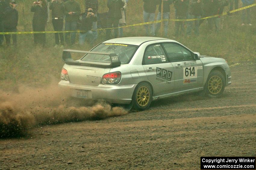 Piotr Wiktorczyk / Alan Dolan powers uphill through the dust on SS1 in their Subaru WRX STi.