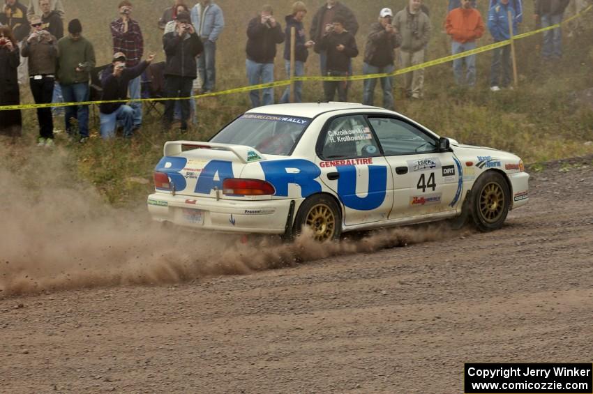 Henry Krolikowski / Cindy Krolikowski power out of a left-hander at the spectator point on SS1 in their Subaru Impreza.